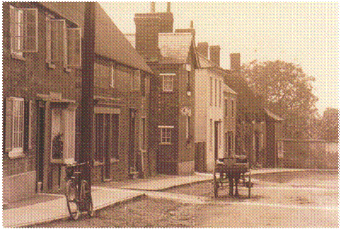 WH High St. North side 1 - This view of High St shows the thatched house (now demolished) thought to have been the home of John Hanbury in the 1840s.